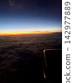 The sunrise sky as seen from inside the airplane 142977889