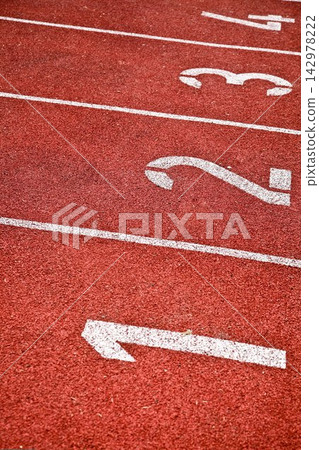 Red Running Track Lanes with White Numbers and Direction Arrow Red Running Track Lanes with White Numbers and Direction Arrow 142978222