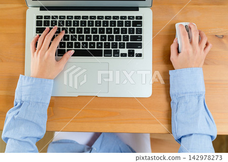 Laptop Keyboard and Mouse on Wooden Desk, Top View Office Workspace Laptop Keyboard and Mouse on Wooden Desk, Top View Office Workspace 142978273