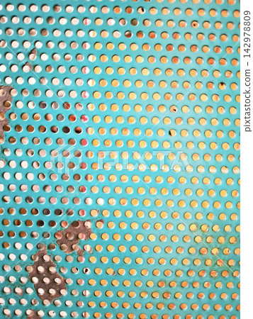Detailed view of turquoise painted metal mesh with industrial circular perforations and weathered rust patches perfect for architectural or design backgrounds. Detailed view of turquoise painted metal mesh with industrial circular perforations and weathered rust patches perfect for architectural or design backgrounds. 142978809