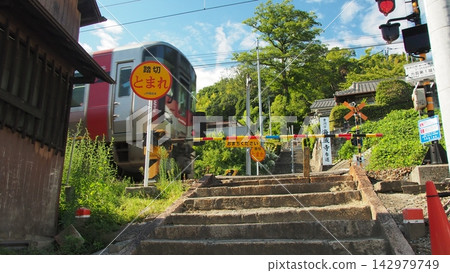 The approach to the shrine that cuts through a JR railway crossing. The approach to the shrine that cuts through a JR railway crossing. 142979749