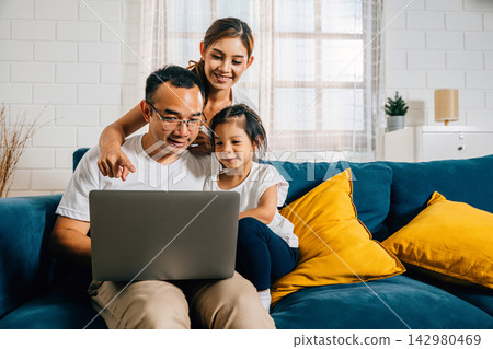 Parents and kids gathered on the couch with a laptop finding happiness in their modern family time Parents and kids gathered on the couch with a laptop finding happiness in their modern family time 142980469