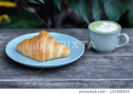 croissant , French croissant or French bread and matcha green tea or matcha green tea latte croissant , French croissant or French bread and matcha green tea or matcha green tea latte 142980935