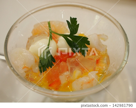 Close-up of a seafood and vegetable salad in a glass. Close-up of a seafood and vegetable salad in a glass. 142981790