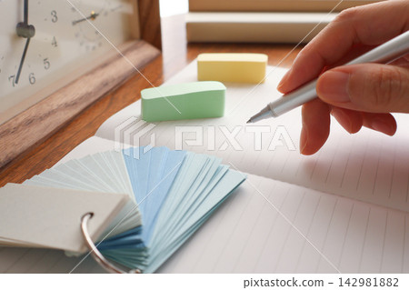 Close-up of a woman's hand writing in a notebook / Study image Close-up of a woman's hand writing in a notebook / Study image 142981882