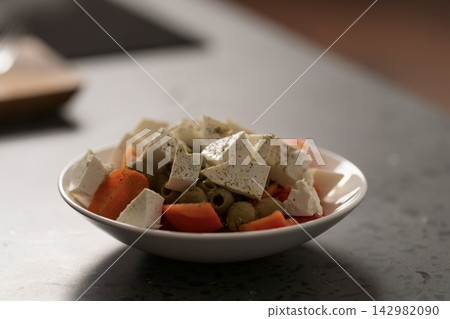 Greek style salad with tomatoes, bell pepper, olives and feta cheese Greek style salad with tomatoes, bell pepper, olives and feta cheese 142982090