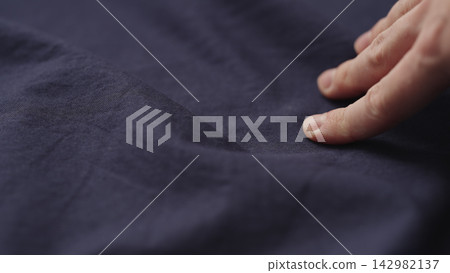 man hand checking blue cotton shirt cloth man hand checking blue cotton shirt cloth 142982137