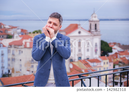 Man plays harmonica outdoors in Lisbon city street Man plays harmonica outdoors in Lisbon city street 142982318