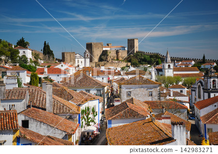 Explore medieval Obidos town with its stunning castle and picturesque rooftops Explore medieval Obidos town with its stunning castle and picturesque rooftops 142983271