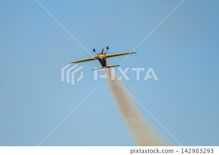 Stunt aerobatic plane performing stunts in air 142983293