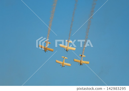 Stunt aerobatic planes performing stunts in air Stunt aerobatic planes performing stunts in air 142983295