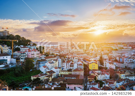 Sunset view over Lisbon with Carmo Convent and 25th of April Bridge Sunset view over Lisbon with Carmo Convent and 25th of April Bridge 142983296