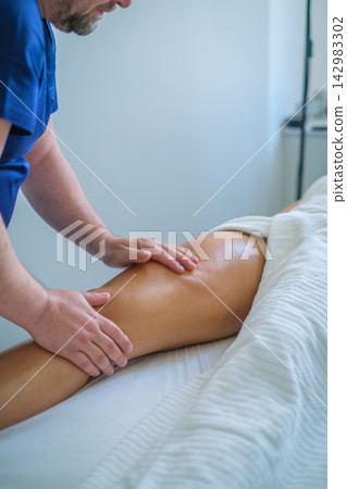 Leg and thigh massage therapy in modern spa salon for relaxation and well-being Leg and thigh massage therapy in modern spa salon for relaxation and well-being 142983302