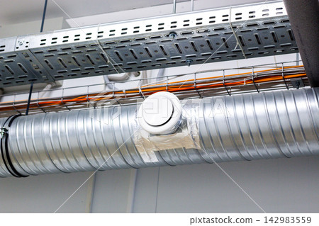 Close-up of modern ceiling ventilation system. Air conditioning, ventilation, ductwork, engineering, building systems, and climate control Close-up of modern ceiling ventilation system. Air conditioning, ventilation, ductwork, engineering, building systems, and climate control 142983559