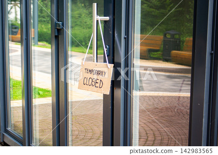 TEMPORARILY CLOSED sign on private shop window. Small local retail business closes because of financial and economic crisis. Entrepreneurs faces market changes TEMPORARILY CLOSED sign on private shop window. Small local retail business closes because of financial and economic crisis. Entrepreneurs faces market changes 142983565