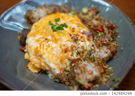 Stir Fried Crispy Pork Belly with Salt and Chili, served in a bowl with rice and omelette Stir Fried Crispy Pork Belly with Salt and Chili, served in a bowl with rice and omelette 142984299