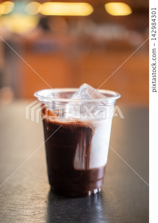 A glass of iced chocolate on the table A glass of iced chocolate on the table 142984301