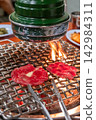 Sliced Sirloin Hanwoo Beef, marbled Korean Style Meat on the Grill. BBQ rare meat with soft focus 142984311