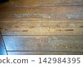 Flooring in an old house that was damaged by termites 142984395