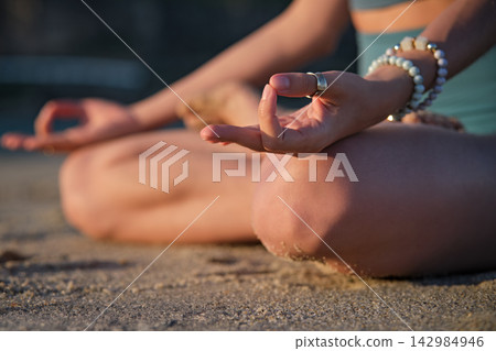 Woman doing Padmasana on the beach during Ashtanga Vinyasa yoga Woman doing Padmasana on the beach during Ashtanga Vinyasa yoga 142984946