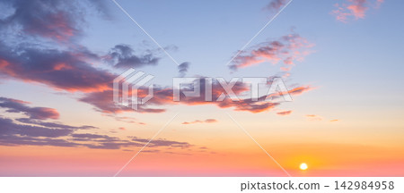 Dramatic sunset sky with vibrant clouds and warm colors over the horizon 142984958
