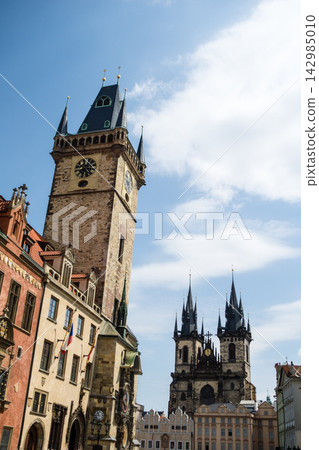Historic stone buildings line the Old Town Square under the bright sunlight – the cityscape of Prague, the capital of the Czech Republic. Historic stone buildings line the Old Town Square under the bright sunlight – the cityscape of Prague, the capital of the Czech Republic. 142985010