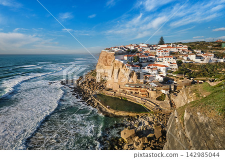 Scenic coastal view of Azenhas do Mar village perched atop cliffs Scenic coastal view of Azenhas do Mar village perched atop cliffs 142985044