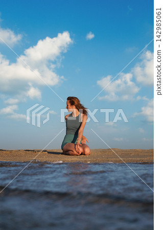 Bharadvajasana Variation Yoga in Vajrasana on Beach at Golden Hour Bharadvajasana Variation Yoga in Vajrasana on Beach at Golden Hour 142985061