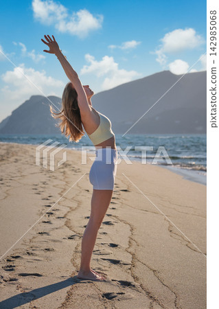 Urdhva Hastasana Upward Salute Yoga Backbend on Beach Urdhva Hastasana Upward Salute Yoga Backbend on Beach 142985068