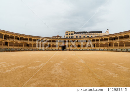 Empty historic bullring arena with tiered stone arcades in Ronda, Spain Empty historic bullring arena with tiered stone arcades in Ronda, Spain 142985845