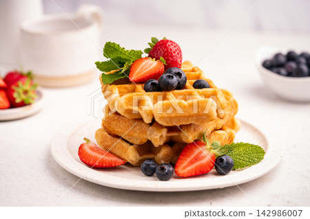 Tasty Belgian waffles with fresh berries Tasty Belgian waffles with fresh berries 142986007