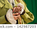 Fashionable woman with manicured nails wearing chic green trench coat 142987203