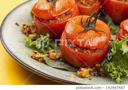 Roasted tomatoes filled with quinoa and vegetable medley Roasted tomatoes filled with quinoa and vegetable medley 142987487