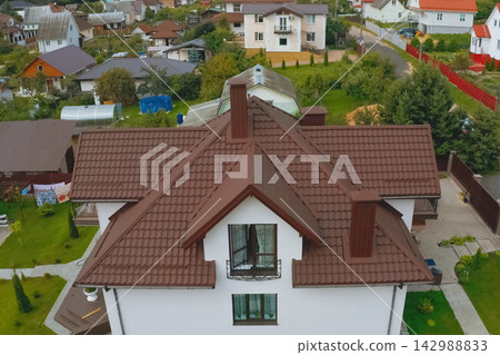 Corrugated metal roof and metal roofing. Modern roof made of met Corrugated metal roof and metal roofing. Modern roof made of met 142988833