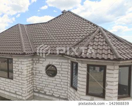 Corrugated metal roof and metal roofing. Modern roof made of met Corrugated metal roof and metal roofing. Modern roof made of met 142988839