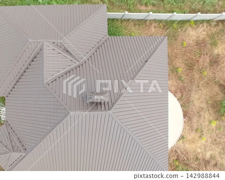 Corrugated metal roof and metal roofing. Modern roof made of met Corrugated metal roof and metal roofing. Modern roof made of met 142988844