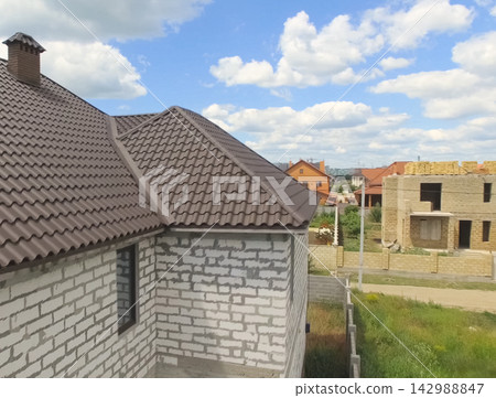 Corrugated metal roof and metal roofing. Modern roof made of met 142988847