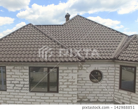 Corrugated metal roof and metal roofing. Modern roof made of met 142988851