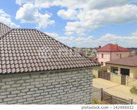 Corrugated metal roof and metal roofing. Modern roof made of met Corrugated metal roof and metal roofing. Modern roof made of met 142988852
