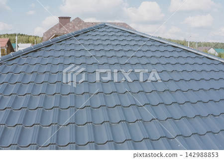 Corrugated metal roof and metal roofing. Modern roof made of met Corrugated metal roof and metal roofing. Modern roof made of met 142988853