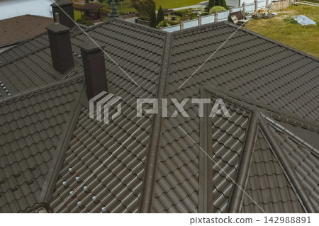 Corrugated metal roof and metal roofing. Modern roof made of metal. 142988891