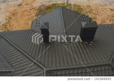 Corrugated metal roof and metal roofing. Modern roof made of metal. Corrugated metal roof and metal roofing. Modern roof made of metal. 142988895