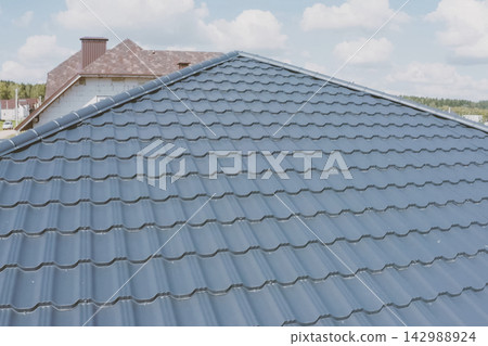Corrugated metal roof and metal roofing. Modern roof made of met Corrugated metal roof and metal roofing. Modern roof made of met 142988924