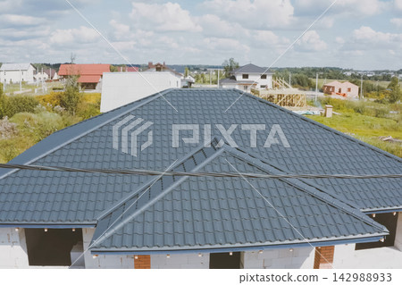 Corrugated metal roof and metal roofing. Modern roof made of met Corrugated metal roof and metal roofing. Modern roof made of met 142988933