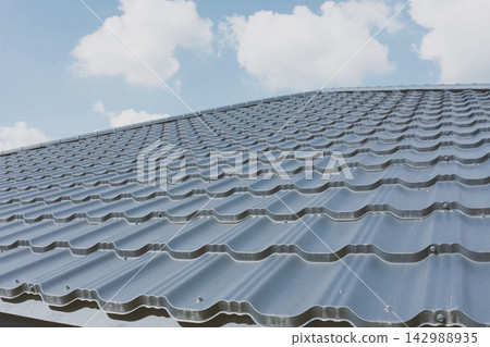 Corrugated metal roof and metal roofing. Modern roof made of met Corrugated metal roof and metal roofing. Modern roof made of met 142988935