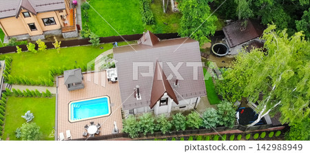 new house, the roof of which is made of metal. Cottage in the countryside. new house, the roof of which is made of metal. Cottage in the countryside. 142988949
