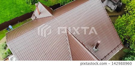 Corrugated metal roof and metal roofing. Modern roof made of met Corrugated metal roof and metal roofing. Modern roof made of met 142988960