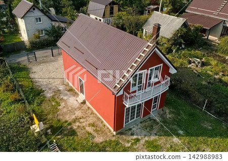 new house, the roof of which is made of metal. Cottage in the countryside. new house, the roof of which is made of metal. Cottage in the countryside. 142988983