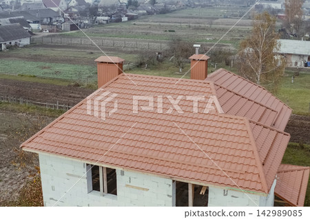 Corrugated metal roof and metal roofing. Modern roof made of metal. Corrugated metal roof and metal roofing. Modern roof made of metal. 142989085