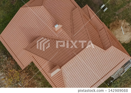 Corrugated metal roof and metal roofing. Modern roof made of metal. Corrugated metal roof and metal roofing. Modern roof made of metal. 142989088